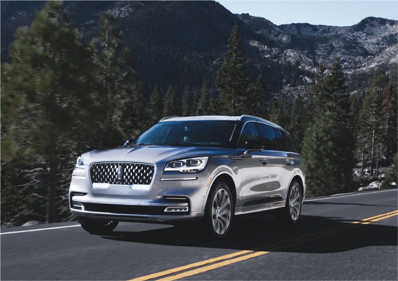 A 2023 Lincoln Aviator® Grand Touring SUV being driven on a winding road to demonstrate the capabilities of all-wheel drive | Lincoln of Coconut Creek in Coconut Creek FL