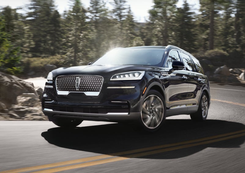 A Lincoln Aviator® SUV is being driven on a winding mountain road | Lincoln of Coconut Creek in Coconut Creek FL