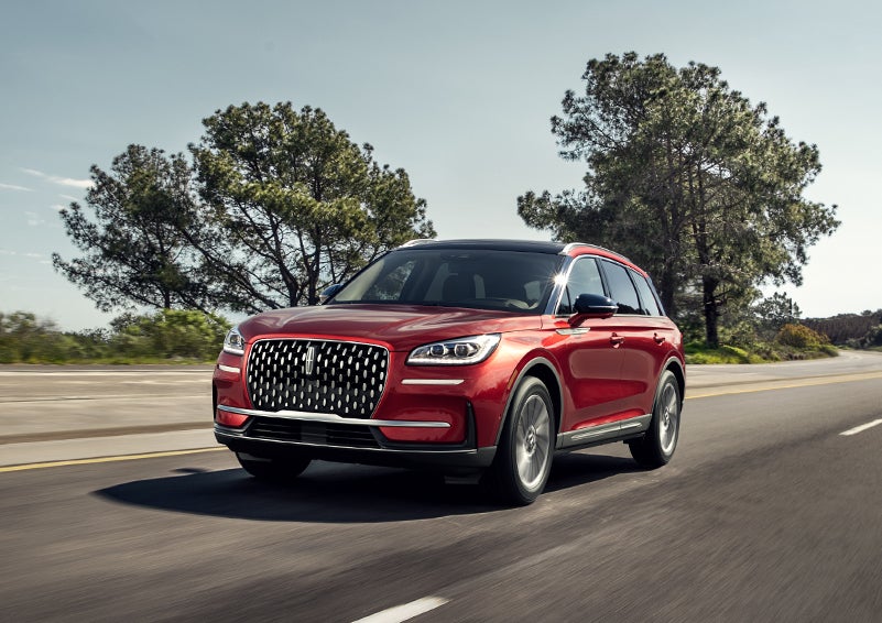 A 2024 Lincoln Corsair® SUV is shown being driven on a country road. | Lincoln of Coconut Creek in Coconut Creek FL