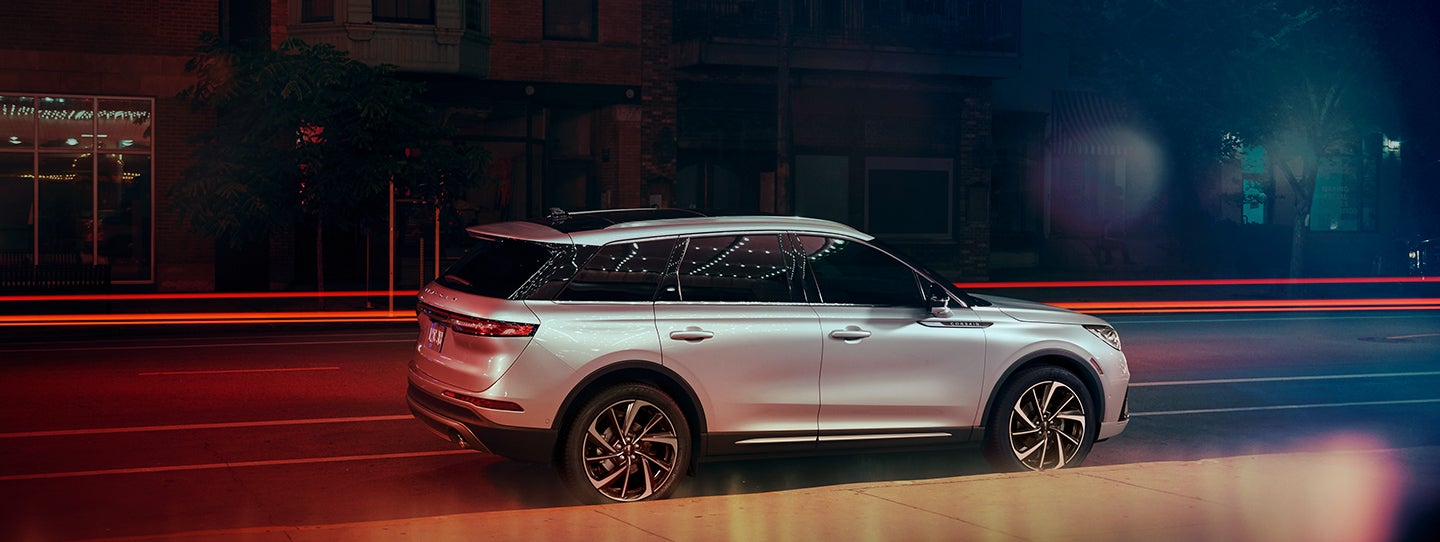 The 2024 Lincoln Corsair® SUV is parked on a city street at night. | Lincoln of Coconut Creek in Coconut Creek FL