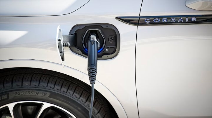 An electric charger is shown plugged into the charging port of a Lincoln Corsair® Grand Touring
model. | Lincoln of Coconut Creek in Coconut Creek FL